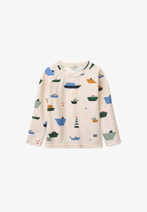 Μπεζ πουκάμισο μακρυμάνικο με πολύχρωμα σχέδια από βάρκες και φάρο. Κατασκευασμένο από λείο ύφασμα με στρογγυλή λαιμόκοψη και μανίκια ράγκλαν.