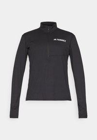 Pullover nero a maniche lunghe con zip a un quarto, dotato di una tasca frontale e del logo bianco "TERREX" sul petto. Tessuto morbido e leggero.