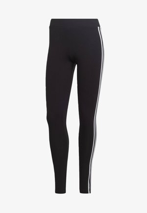 Black leggings made of stretch fabric with a high waistband, featuring contrasting white side stripes and a fitted design.