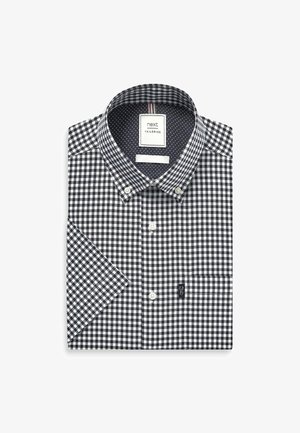 Schwarz-weiße karierte Kurzarmbluse mit Button-Down-Kragen, ausgestattet mit einem marinefarbenen Innenfutter mit Punkten und einem kleinen Logosticker am Saum.