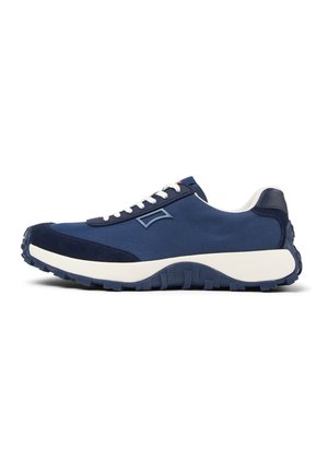 Navy blue athletic shoe with a smooth textile upper, suede accents, and a thick white midsole, featuring a rugged textured rubber outsole.