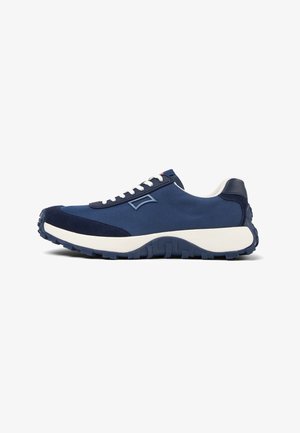 Navy blue athletic shoe with a smooth textile upper, suede accents, and a thick white midsole, featuring a rugged textured rubber outsole.