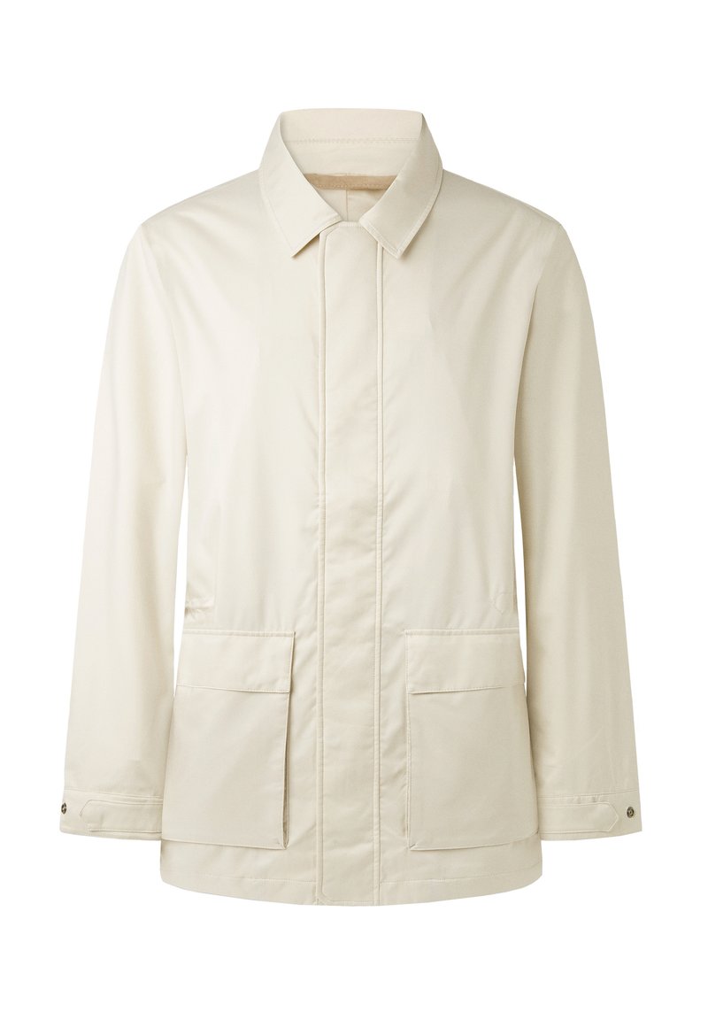 Veste crème à manches longues avec col, poches avant, poignets à boutons et fermeture frontale dissimulée.