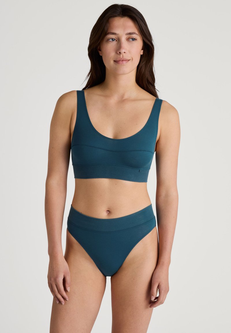 Teal seamless bralette and high-waisted brief set. Soft fabric, scoop neck, wide straps, and elasticized waistband. Simple design, no patterns.