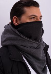 Dark gray scarf with a soft texture, wrapped snugly around the neck and face, featuring contrasting black edging and a brown leather accent.