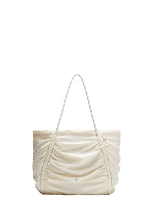 Sac fourre-tout doux de couleur crème avec texture de tissu froncée et anses fines rayées, avec un petit logo circulaire au centre avant.