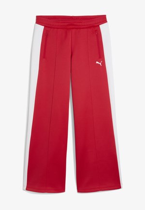 Punased sportpüksid valgete külgbandidega. Omavad tõmblukuga taskuid ja tekstureeritud vöökohta. Valmistatud venivast ja siledast kangast.