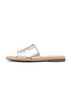 Flat beige slide sandal with wide leather strap and woven detail along the sole edge, shown in side profile on white background.
