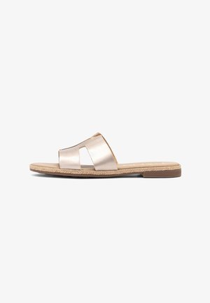 Flat beige slide sandal with wide leather strap and woven detail along the sole edge, shown in side profile on white background.