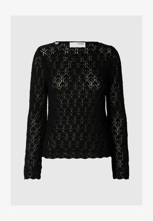 Top en dentelle noire à manches longues avec un motif en losange, col rond et coupe légèrement ample. Le tissu texturé ajoute un intérêt visuel.