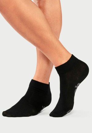 Schwarze Knöchelsocken mit geripptem Saum, glatter Textur und grauen Akzenten an der Seite. Entwickelt für Komfort und eine enge Passform.