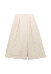 Lys beige culotter med en krøllet tekstur, der har brede ben og to sidelommer, designet til en løs pasform.