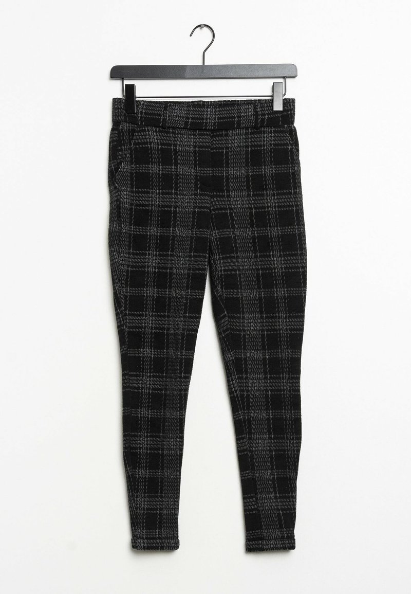 Pantalones de cuadros en negro y gris con un diseño ajustado, hechos de una tela texturizada. Cintura elástica y sin cierres visibles. Adecuados para un uso casual.