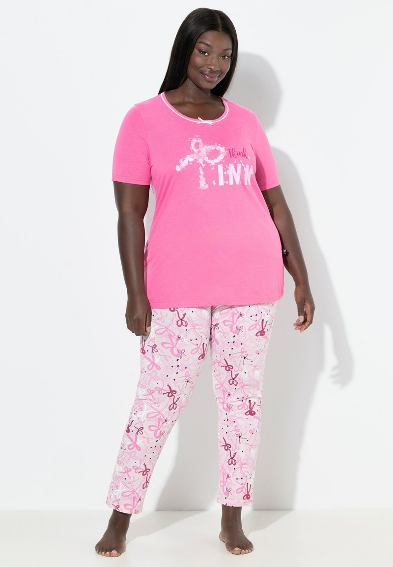 Růžový top s krátkým rukávem a bílým lemováním má grafiku "Think PINK". Odpovídající růžové pyžamové kalhoty zobrazují rozptýlené vzory nůžek. Bavlněný materiál.