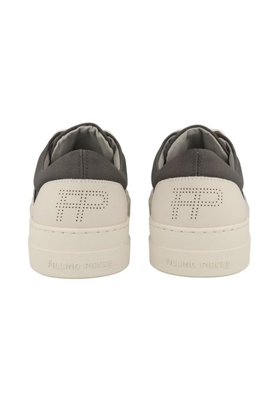 Pair of white sneakers with gray fabric around the ankle, perforated "FP" logo on heels, and "FILLING PIECES" embossed on soles.