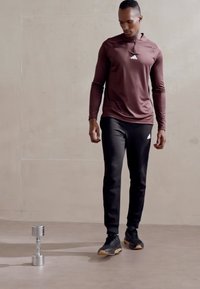 adidas Sportswear ESSENTIALS - Teplákové kalhoty - black