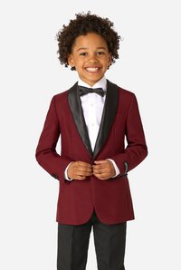 Burgundy blazer with black satin lapels, worn over a white shirt and bow tie. Black pants, accented with cuff buttons. Smooth texture.