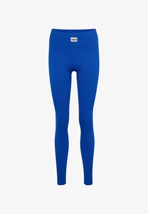Blauwe, geribbelde legging in volledige lengte met een hoge tailleband en een klein wit merklabel in het midden aan de voorkant.