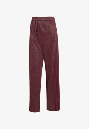 Glanzende bordeauxrode sportbroek met elastische tailleband, zijzakken, drie zijstrepen en een klein logo op de bovenbenen.