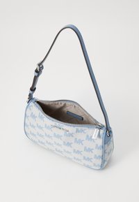 Light blue canvas handbag with MK logo pattern, zip closure, and adjustable strap. Features silver hardware and a beige interior lining.