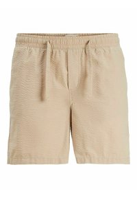 Shorts en tissu texturé beige avec taille élastique et cordon de serrage, dotés de poches latérales et d'une coupe courte et décontractée.