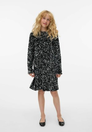 Vestito nero con paillettes, maniche lunghe, scollatura rotonda e orlo svasato. Tessuto morbido con paillettes lucide e riflettenti che coprono l'intero capo.
