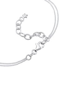 Silver chain bracelet featuring interlinked oval links and a lobster clasp. Marked with "925" for sterling silver authenticity.