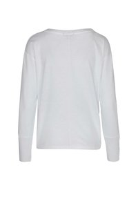 White long-sleeve top featuring a relaxed fit, round neckline, and ribbed cuffs. Smooth texture with a center seam at the back.