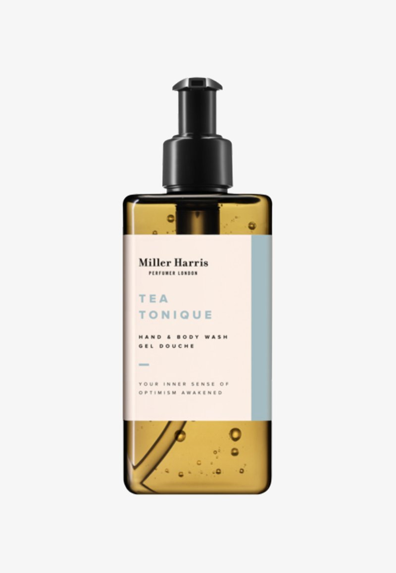 Gel lavant pour mains et corps Miller Harris Tea Tonique dans une bouteille ambre avec pompe noire, gel transparent et étiquette blanche-bleue.