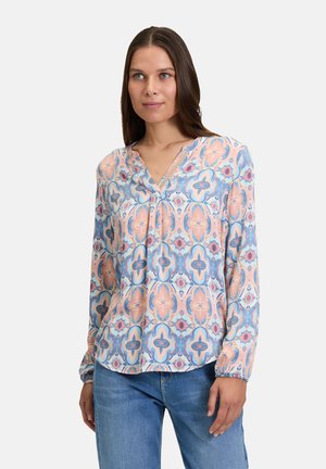 Long-sleeve, lightweight blouse in pastel colors featuring a geometric pattern. V-neckline with subtle detailing and elastic cuffs.