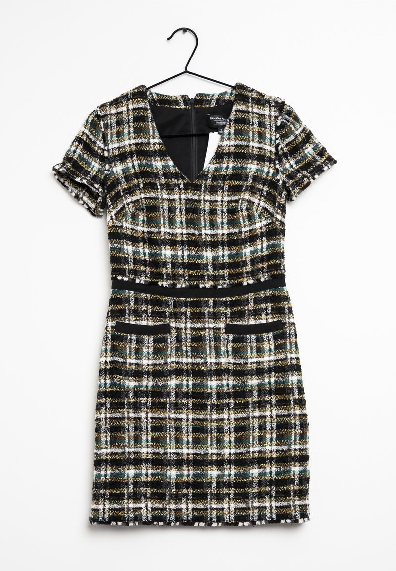 Šaty s krátkými rukávy z černo-bílého tvídu s zelenými a zlatými akcenty, s výstřihem do V, přiléhavým pasem a dvěma předními kapsami.