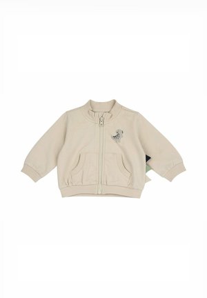 Giacca beige per bambino con cerniera frontale, polsini a coste, due tasche frontali e una piccola grafica di un cane sul petto sinistro.