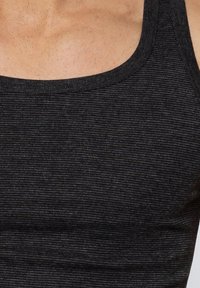 Black tank top with a ribbed texture, round neckline, and wide straps, highlighting a fitted silhouette. Smooth fabric with subtle sheen.
