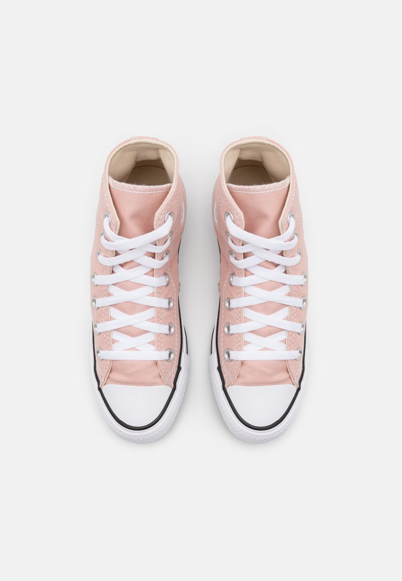Zapatillas altas de lona suave en color rosa claro con cordones blancos, punta de goma y detalles en negro a lo largo de la suela. Textura suave, forma redondeada.