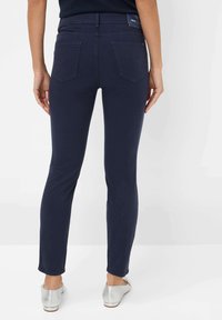 Námořnické džíny se slim fit, zadními kapsami a hladkým povrchem. Pas obsahuje štítek a lem je zakončen čistým okrajem.