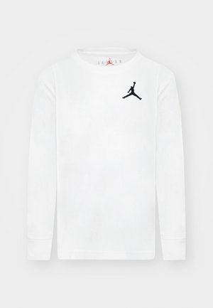 Fehér, hosszú ujjú, pamut ing, fekete Jumpman logóval a bal mellrészen és kerek nyakkivágással. Laposan varrott mandzsetták.