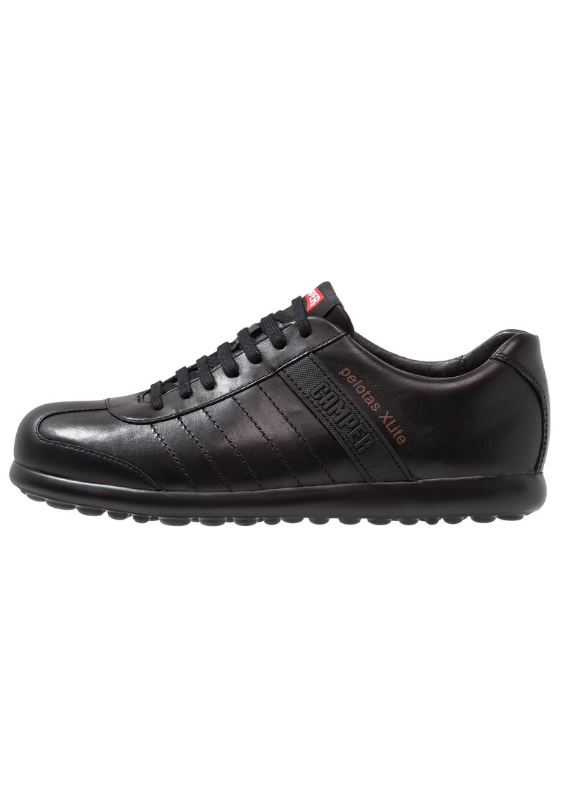 Black leather sneaker with a rounded toe, lace-up design, horizontal stitching accents, and a textured side panel with logo detailing.