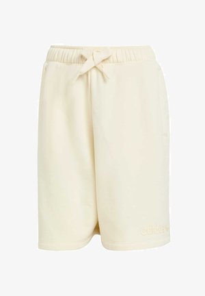 Cream-colored shorts with an elastic waistband and bow tie detail, featuring side pockets and a subtle embossed logo. Soft fabric texture.