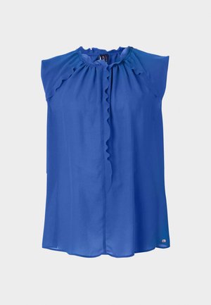 Blue sleeveless blouse with a ruffled neck, smooth texture, and a slightly loose fit. Features a button closure and a subtle logo at the hem.