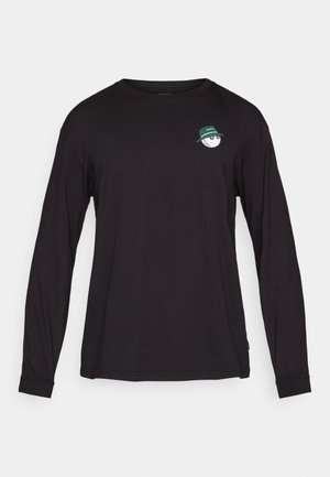 Svart langermet skjorte laget av bomull. Har et lite brodert grafikk av et hvitt ansikt med en grønn hatt på venstre bryst.