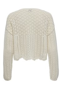 Cárdigan corto de punto color crema con textura calada, mangas largas y dobladillo festoneado. Presenta patrones de diamantes y triángulos.