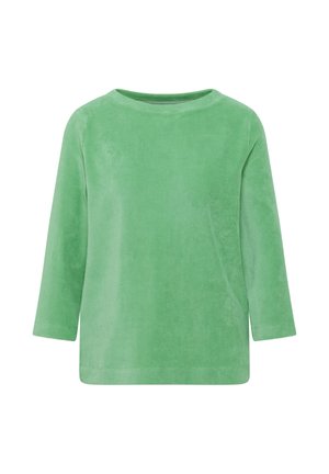 Chemise en velours côtelé verte à manches longues avec un col rond et une coupe décontractée, présentée sur un fond blanc.