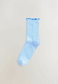 Jasnoniebieska bawełniana skarpetka o prążkowanej fakturze z falbanką u góry. Gładkie wykończenie, długość do kostki.