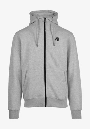 Grijze rits hoodie van zacht materiaal. Heeft een zwarte rits, twee voorzakken en een klein zwart gorilla logo op de borst.