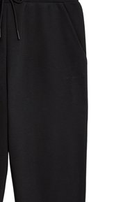 Sorte sweatpants lavet af blødt stof, med en elastisk talje og snoretræk, sidelommer og en diskret logo detalje.