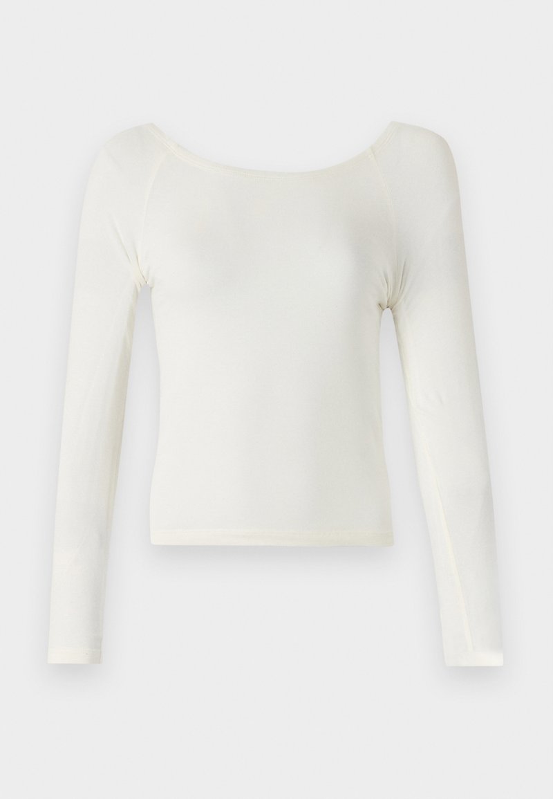 Maglietta a maniche lunghe di colore bianco sporco, realizzata in un tessuto morbido con scollatura rotonda e design aderente; presenta cuciture minime e una superficie liscia.