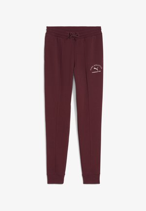 Burgundy sweatpants with an elastic waistband, drawstring, side pockets, and white logo text on the left thigh. Smooth fabric texture.