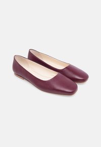 Burgundy leather ballet flats with a smooth finish, square toe design, and beige interior. Features a low profile and minimalistic shape.