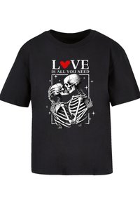 Black cotton t-shirt featuring a skeleton design, holding each other, with the text "LOVE IS ALL YOU NEED" in white and red.