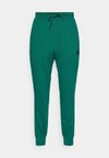 FEELCOZY - Pantalon de survêtement - collegiate green/black